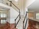 Grand two-story foyer featuring dark wood floors and staircase with white railings at 13237 Fremington Rd, Huntersville, NC 28078