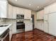 Bright kitchen with stainless steel appliances, white cabinetry, and hardwood floors at 13237 Fremington Rd, Huntersville, NC 28078