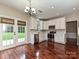 Charming kitchen with stainless steel appliances, white cabinetry, and french doors to backyard at 13237 Fremington Rd, Huntersville, NC 28078