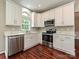 Modern kitchen featuring stainless appliances, white cabinets, and quartz countertops at 13237 Fremington Rd, Huntersville, NC 28078