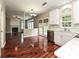 Kitchen with white cabinets, stainless steel dishwasher and view to the living room at 13237 Fremington Rd, Huntersville, NC 28078