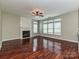 Bright living room featuring a cozy fireplace, ceiling fan, and large windows at 13237 Fremington Rd, Huntersville, NC 28078