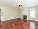 Living room featuring a decorative fireplace, ceiling fan, and hardwood floors at 13237 Fremington Rd, Huntersville, NC 28078