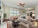 Staged living room featuring a fireplace, sofa, chairs, and rug at 13237 Fremington Rd, Huntersville, NC 28078