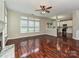 Bright living room with hardwood floors, ceiling fan and large windows overlooking the backyard at 13237 Fremington Rd, Huntersville, NC 28078