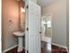 Powder room featuring a pedestal sink, mirror and decorative lighting at 13237 Fremington Rd, Huntersville, NC 28078