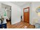 Inviting entryway with hardwood floors, white walls, and attractive front door leads to the bedroom at 139 5Th St, Huntersville, NC 28078