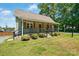 Inviting exterior with a cozy front porch, well-maintained lawn, and charming details at 139 5Th St, Huntersville, NC 28078