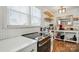 Modern kitchen details featuring stainless steel stove, stylish countertops, and floating shelves at 139 5Th St, Huntersville, NC 28078