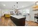 Open-concept kitchen with island seating, stainless appliances, and hardwood floors at 139 5Th St, Huntersville, NC 28078