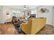 Bright living room boasts wood floors, large windows, and stylish decor with yellow couches and modern accents at 139 5Th St, Huntersville, NC 28078