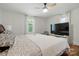 Bright main bedroom features a ceiling fan, natural light, and a large TV for ultimate relaxation at 139 5Th St, Huntersville, NC 28078