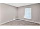 This bedroom has neutral carpet, a window and white trim work that makes it feel calming at 143 Phifer Cir, Kings Mountain, NC 28086