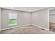 Well-lit bedroom with soft carpeting, neutral paint, a bright window view, and modern recessed lighting at 143 Phifer Cir, Kings Mountain, NC 28086