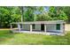 Charming single-story home with a covered front porch and brick-accented support beams, nestled amongst lush trees at 143 Phifer Cir, Kings Mountain, NC 28086