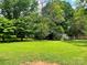 Large grassy backyard lined by mature trees at 1824 Ebinport Rd, Rock Hill, SC 29732