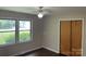 A secondary bedroom with hardwood floors, natural light from the two windows, and a wooden closet at 1824 Ebinport Rd, Rock Hill, SC 29732
