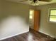 A secondary bedroom features hardwood floors and an ensuite bathroom accessible through a wooden door at 1824 Ebinport Rd, Rock Hill, SC 29732