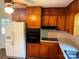 Functional kitchen featuring wooden cabinets, a white refrigerator, and essential appliances at 1824 Ebinport Rd, Rock Hill, SC 29732