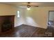 Inviting living room with wood paneling, hardwood flooring, and a classic brick fireplace at 1824 Ebinport Rd, Rock Hill, SC 29732