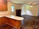Spacious living area with hardwood floors, connecting to the kitchen with a cozy fireplace at 1824 Ebinport Rd, Rock Hill, SC 29732