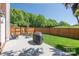 Spacious backyard with a well-maintained lawn, patio area, wooden fence, and comfortable outdoor seating at 18524 Mizzenmast Ave, Cornelius, NC 28031