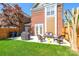 Spacious backyard with a patio, grill, lush lawn, and a privacy fence, ideal for outdoor activities and relaxation at 18524 Mizzenmast Ave, Cornelius, NC 28031