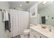 Bathroom with a white vanity, neutral walls, and a shower with a curtain at 18524 Mizzenmast Ave, Cornelius, NC 28031