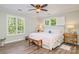 Cozy bedroom with hardwood floors, plantation shutters, and natural light at 18524 Mizzenmast Ave, Cornelius, NC 28031