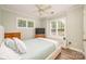 Bedroom with hardwood floors, windows with plantation shutters, and neutral tones at 18524 Mizzenmast Ave, Cornelius, NC 28031