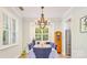 Open Dining area with rustic chandelier, bright windows, and wood floors at 18524 Mizzenmast Ave, Cornelius, NC 28031