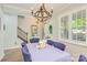 Cozy dining room with rustic chandelier, wainscoting, wood floors and lots of natural light at 18524 Mizzenmast Ave, Cornelius, NC 28031
