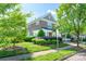 Beautiful two-story brick home with lush landscaping, mature trees, and well-maintained lawn on a sunny day at 18524 Mizzenmast Ave, Cornelius, NC 28031