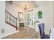 Inviting foyer features wood-look flooring, staircase with iron spindles, and a bright entry door at 18524 Mizzenmast Ave, Cornelius, NC 28031