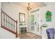 Bright foyer with wood-look floors, staircase with iron spindles, and decorative touches at 18524 Mizzenmast Ave, Cornelius, NC 28031