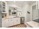 Bright kitchen featuring white cabinets, stainless steel appliances, granite counters, and open view to the living area at 18524 Mizzenmast Ave, Cornelius, NC 28031