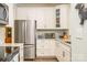 Well lit kitchen with stainless appliances, granite counters, and stylish tile backsplash at 18524 Mizzenmast Ave, Cornelius, NC 28031