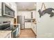 Well lit kitchen with stainless appliances, granite counters, and stylish tile backsplash at 18524 Mizzenmast Ave, Cornelius, NC 28031