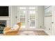 Bright living room boasting natural light, hardwood floors, and access to the outdoor patio area at 18524 Mizzenmast Ave, Cornelius, NC 28031