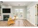 Stylish living room featuring a fireplace, hardwood floors, and convenient access to the laundry room at 18524 Mizzenmast Ave, Cornelius, NC 28031