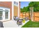 Cozy backyard patio with outdoor seating, a grill, and a privacy fence surrounded by lush greenery at 18524 Mizzenmast Ave, Cornelius, NC 28031