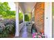 Charming front porch with slate flooring, stylish seating, and a view of the lush, landscaped surroundings at 18524 Mizzenmast Ave, Cornelius, NC 28031