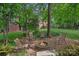 Cozy backyard fire pit with stone surround and seating, perfect for outdoor relaxation at 202 Whitmyre Ct, Fort Mill, SC 29715