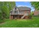 Expansive backyard featuring a deck, screened porch, and well-maintained lawn, ideal for outdoor enjoyment at 202 Whitmyre Ct, Fort Mill, SC 29715