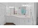 Bathroom featuring double sinks with white cabinets, large mirrors, and modern fixtures at 202 Whitmyre Ct, Fort Mill, SC 29715