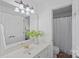 Neutral bathroom with white vanity, floral accents, and shower at 202 Whitmyre Ct, Fort Mill, SC 29715