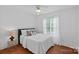 Cozy bedroom with hardwood floors, natural light, and neutral decor with lots of pillows at 202 Whitmyre Ct, Fort Mill, SC 29715