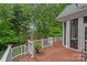 Wooden deck with white railings overlooking a lush backyard, perfect for outdoor entertaining at 202 Whitmyre Ct, Fort Mill, SC 29715