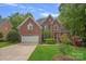 Beautiful brick two-story home with manicured lawn and attached two-car garage at 202 Whitmyre Ct, Fort Mill, SC 29715