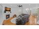 Cozy living room with a fireplace, a plush sectional sofa, and hardwood flooring at 202 Whitmyre Ct, Fort Mill, SC 29715